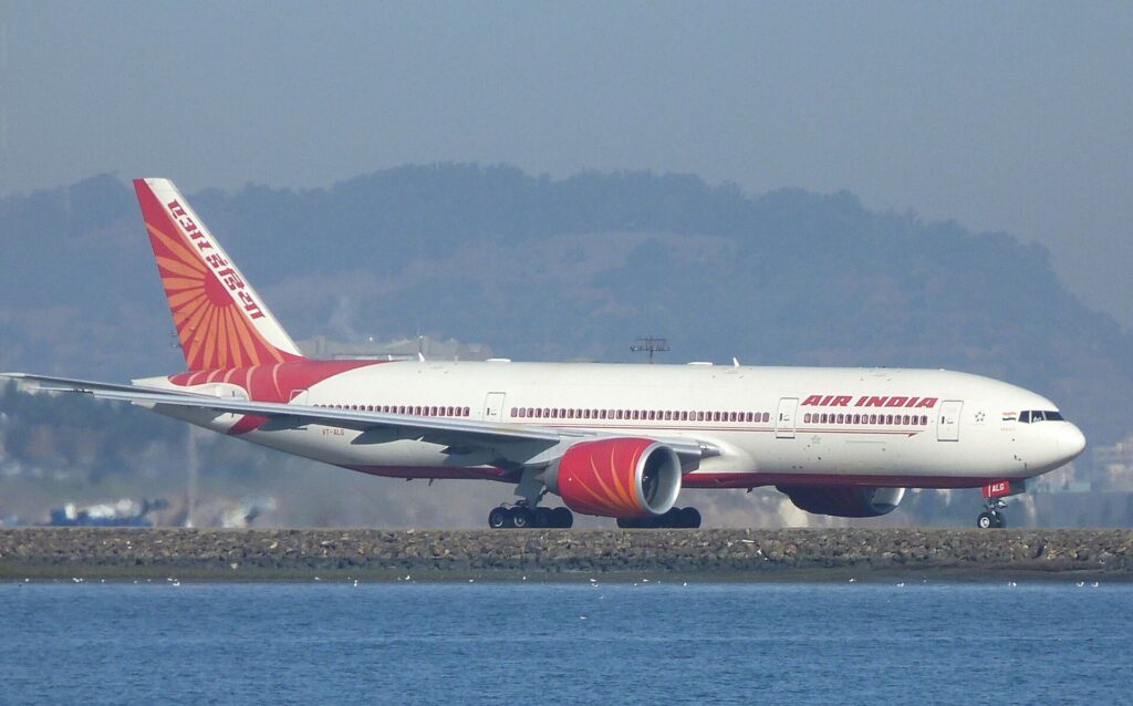 Air India Boeing 777-200LR VT-ALG on the runway at San Francisco International Airport with water in the foreground