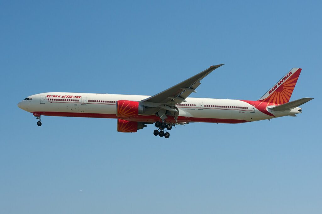 Air India Boeing 777-300ER registration VT-ALJ in flight with landing gear down