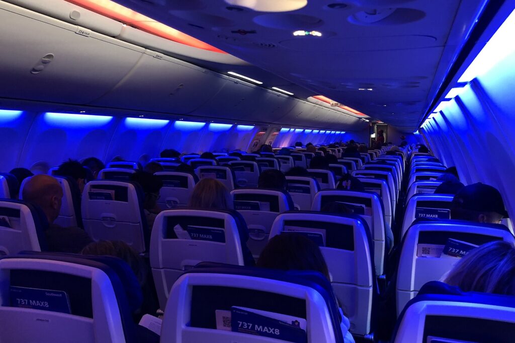 Economy cabin of a Southwest Airlines Boeing 737 MAX 8 with blue mood lighting