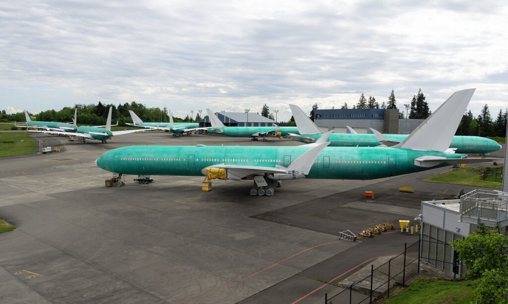 Several unpainted Boeing 777-9 aircraft parked on the flight line at Paine Field, Everett
