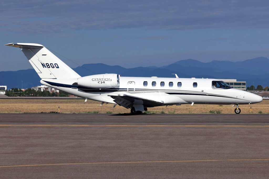 Cessna Citation CJ4 N8GQ taxiing with mountains behind