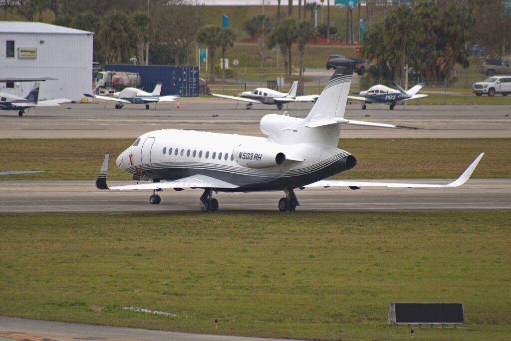 Three-engine Dassault Falcon 900LX N503RH taxiing at Daytona Beach