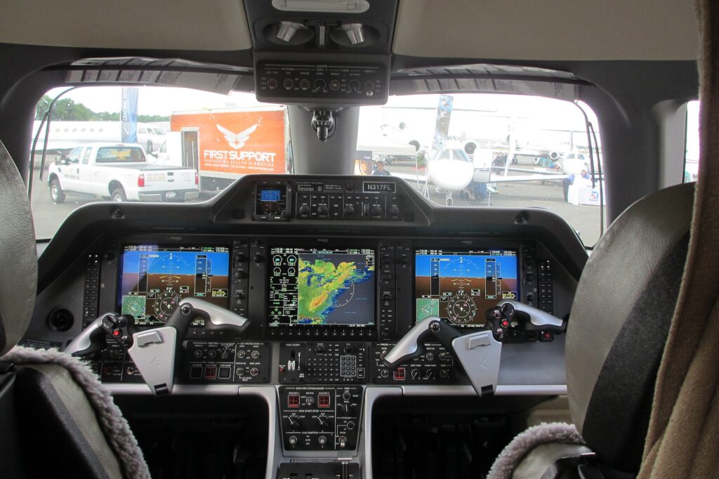 Embraer Phenom 300 cockpit with three large Garmin screens