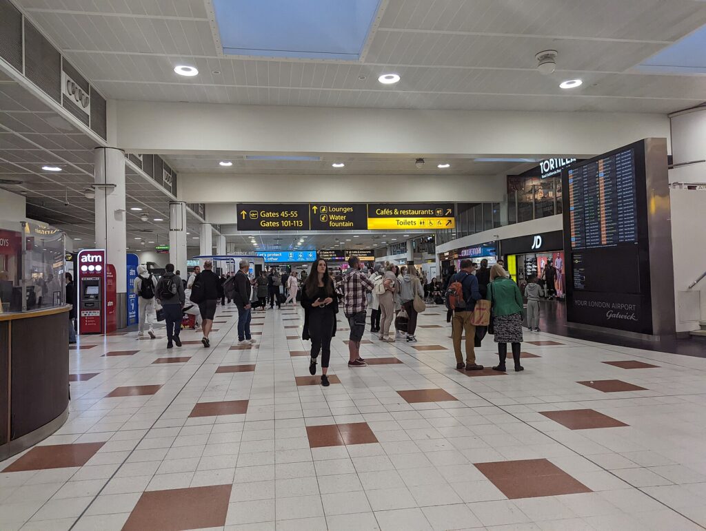Passengers walking through the departures area of Gatwick Airport North Terminal