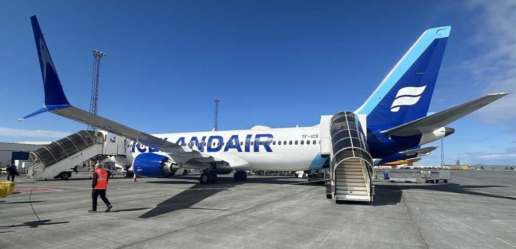 Icelandair aircraft TF-ICS parked at a remote stand at Keflavik airport with boarding stairs