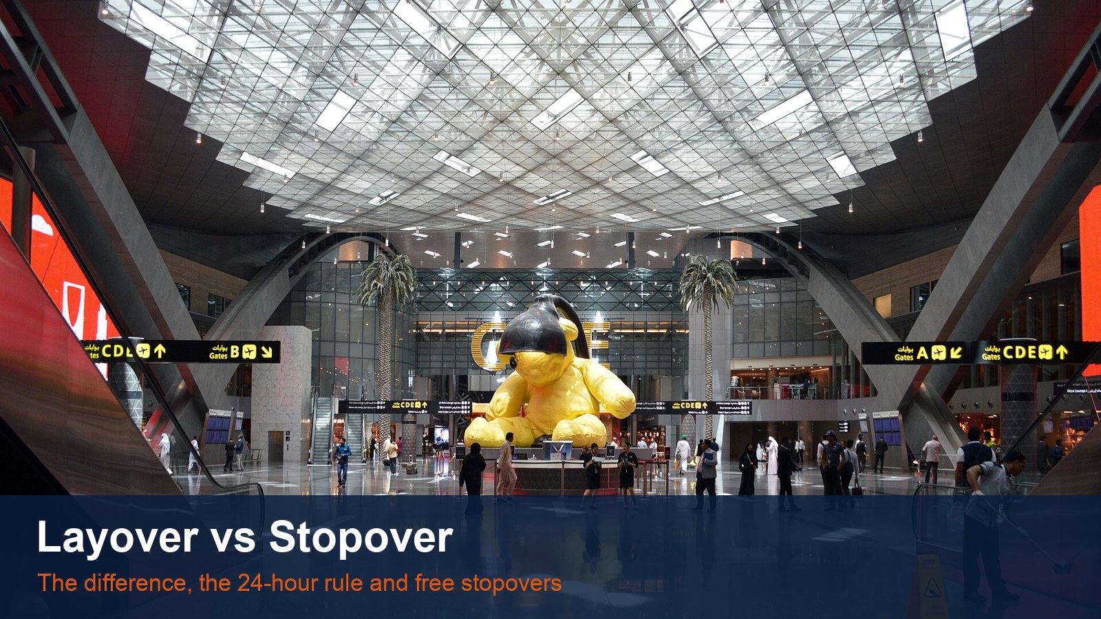 The central hall of Doha Hamad International Airport with its giant yellow teddy bear sculpture, with the words Layover vs Stopover
