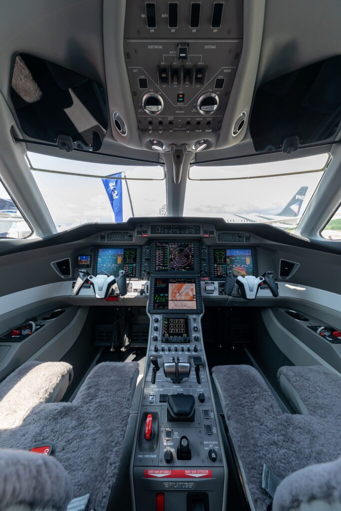 Pilatus PC-24 cockpit with four large Honeywell screens and two control yokes