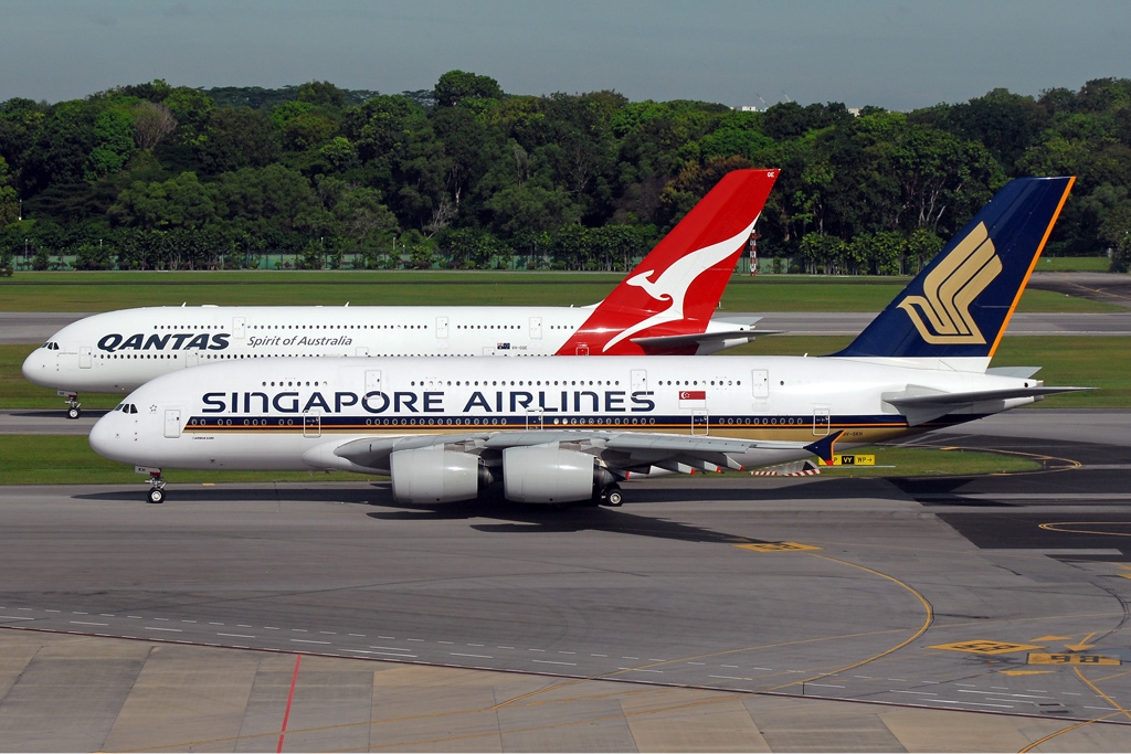 Qantas and Singapore Airlines Airbus A380s taxiing side by side at Singapore Changi Airport
